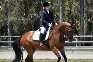 Taree trainer Coralie Burnett aboard one of he dressage horses.