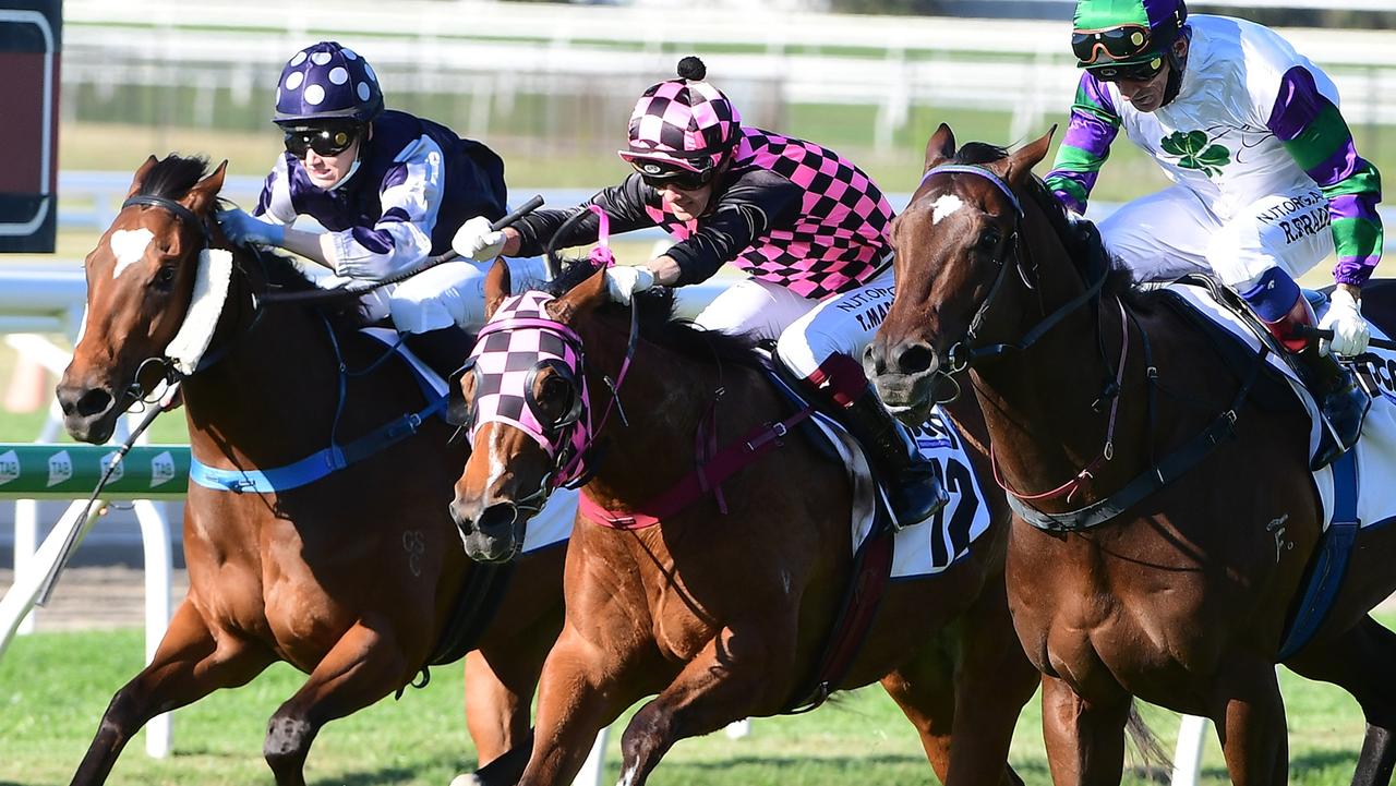 Startantes (pink and black) and jockey Taylor Marshall thread through the gap to beat Alpine Edge (right) and Glorious Ruby at Doomben. Picture: Trackside Photography