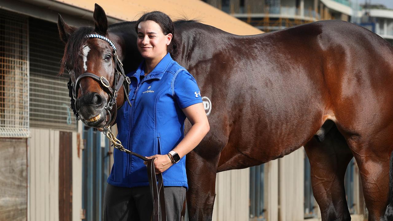 Trekking with stablehand Lizzy Grima ahead of the Doomben 10,000. Picture: Liam Kidston