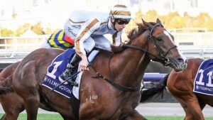 Dice Roll surging to victory at Flemington under jockey Fred Kersley. Picture: Racing Photos