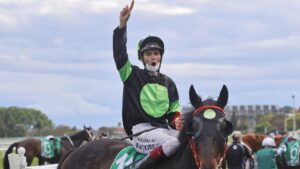 Regan Bayliss celebrates on returning to scale after winning the Epsom on Private Eye. Picture: Mark Evans–Getty Images